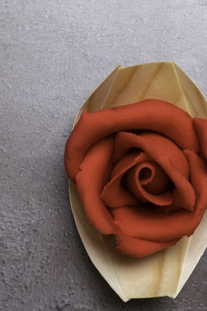celebration red marzipan rose in wooden box on grey backgroundの写真素材