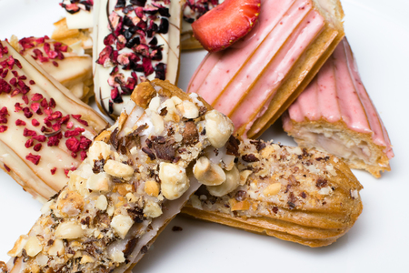Sweet delicious colorful french eclairs. Group of french dessert. Eclair background. French pastry...