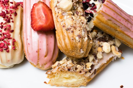 Sweet delicious colorful french eclairs. Group of french dessert. Eclair background. French pastry...