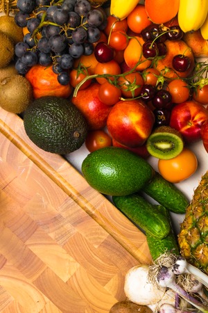 Mediterranean Food background. Assortment of fresh fruits and vegetables, tomatoes, pineapple, bananas, kiwi, mushrooms, garlic, cucumbers, berries, avocado vegetable peaches apricots cherry nitrites Top viewの写真素材