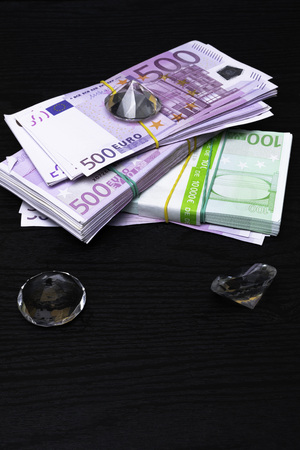 money 500, 100 euro cash on the black table with crystal diamonds, gemsの写真素材