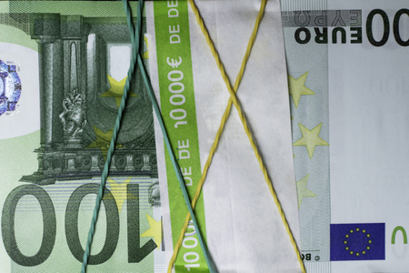 Pile of one hundred euro banknotes, 10000, isolated on the black background, clipping path included....