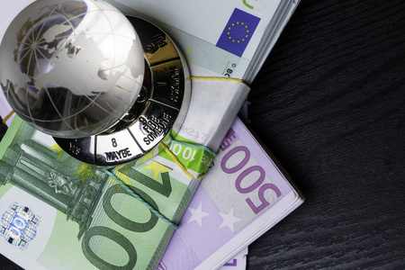 glass earth with choice and big amount euro cash 500, 100 on the black wooden backgroundの写真素材