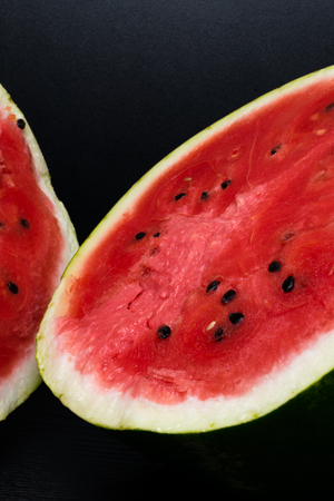 delicious watermelon cut in halves isolated on black background with clipping pathの写真素材