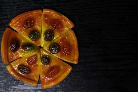 color sweet slices jellies pizza background in lack wooden table