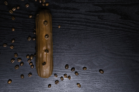 Traditional french coffee eclairs with chocolate on woodn backgroundの写真素材