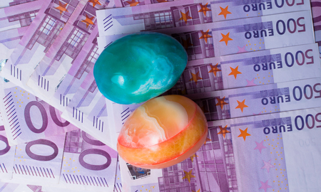 Money background - Five hundred 500 euro bills banknotes with color eggs, pile, top viewの写真素材