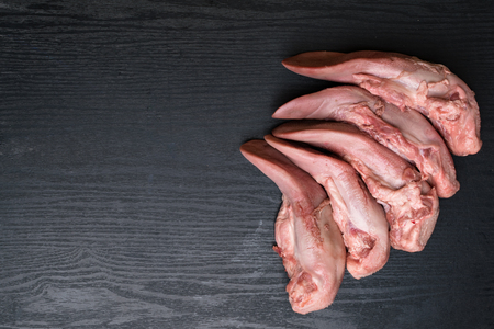 raw pork or beef tongues on black wooden, gourment food conceptionの写真素材