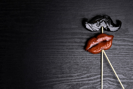 carnival party accessories candy women red lips and man beard on a black background, love concept, man and women, 14th february, weedingの写真素材
