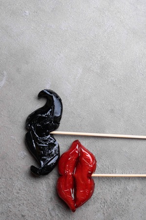 carnival party accessories candy women red lips and man beard on a black background, love concept, man and women, 14th february, weedingの写真素材