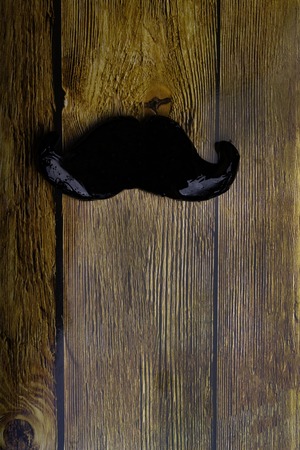 moustache symbol on wooden texture, Fake moustache on vintage background.. Photo props mustaches. Birthday and Party Set and wedding. Flat lay, top view, copy spaceの写真素材