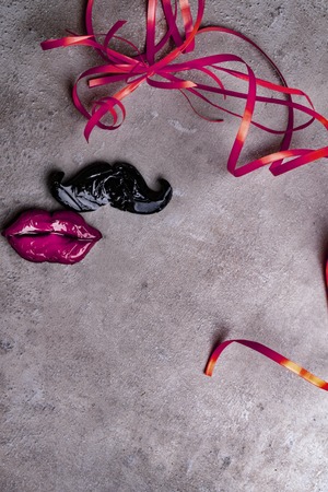 carnival party accessories candy women red lips and man mustache on a grey stone background, love concept, man and women, 14th february, weeding, heterosexualの写真素材