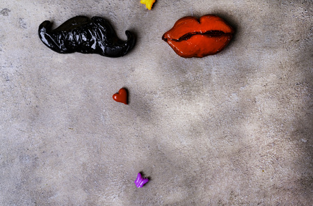 Photo booth props mustache, lips, butterflies sticks on stone grey board background. Birthday and Party Set and wedding. Couple love and sex concept, relationsの写真素材