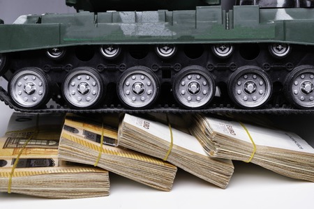 Close up green tank toy placed on euro banknotes pile. business and economy war. new world war from business and economy concept. Concept of expense and cost of war.の写真素材