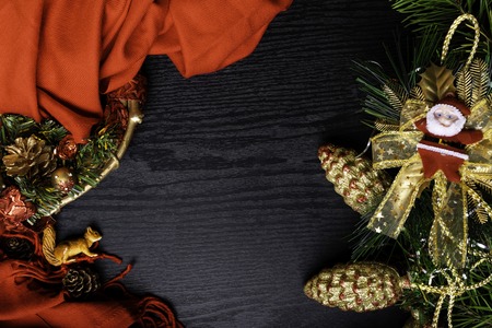 Christmas card Merry Christmas with frame decorated with Santa Claus, red scarf, wreath, and squirrel on wooden background. Flat lay, top view, copy space.の写真素材