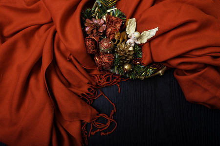 Christmas spirit with wreath, angel, squirrel toy, pine cones on red background, copy spaceの写真素材