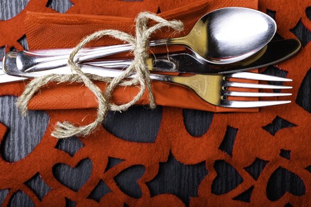 Festive table set for celebration St. Valentine's Day,Fork, knife, napkin, hearts. Celebrate valentine's day. Serving, Table decoration table set with a decorative heart. Image of dinner on Valentines day. Top viewの写真素材