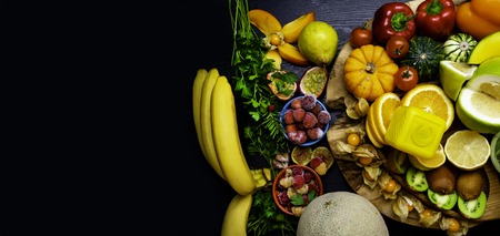 Vitamin C in fruits and vegetables. Natural products rich in vitamin C as oranges, lemons, pepper, kiwi, parsley leaves, garlic, bananas, mango, cabbage, melon, berry, pumpkin, tomatoes, mango, persimmon, passion fruit physalis kiwi fig raspberry strawberry pearの写真素材