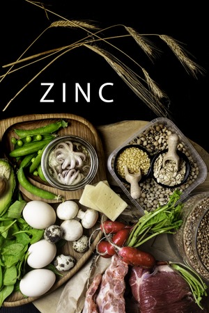 Foods Highest in Zinc as octopus in oil, beef, buckwheat, yellow cheese, spinach, avokado,pea, mushrooms, bean, radishes eggs with inscription Healthy diet food Top viewの写真素材