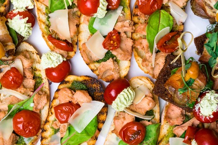 Delicious Italian antipasti bruschetta with tomato, meat pate, olives and tuna cream, mozzarella ....