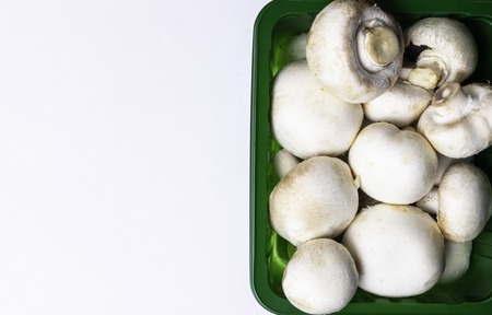 green Box of Fresh organic Mushrooms - isolated on white