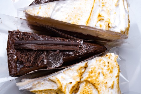 whipped cream and black chocolate delicious cakes isolated on white, holiday and celebrate concept