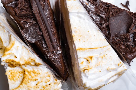 whipped cream and black chocolate delicious cakes isolated on white, holiday and celebrate conceptの写真素材