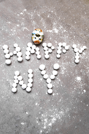 piggy toy with berry text happy new year, on grey background with snowの写真素材
