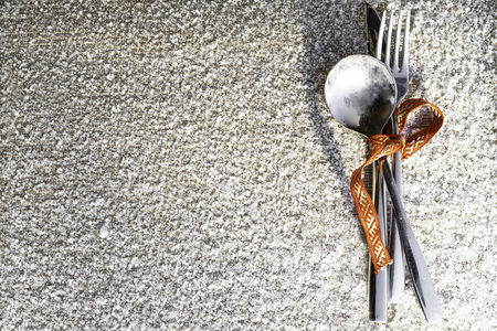 Christmas and new year silverware for celebration as invitation design background with red ribbon on snowy backgroundの写真素材