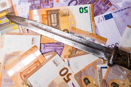 A crime scene - a knife on a pile of euro cash money, robbery conceptの写真素材