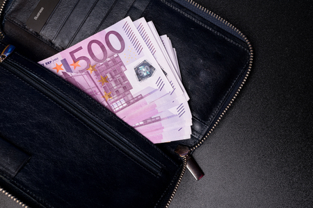 leather black wallet full of euro bank notesの写真素材