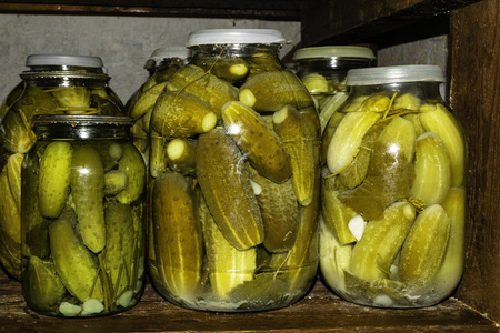 Glass jar with pickled cucumbersの写真素材