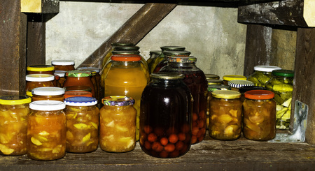Jars with variety of pickled vegetables, fruits, compote, cherry juice,tomatoes, Preserved foodの写真素材