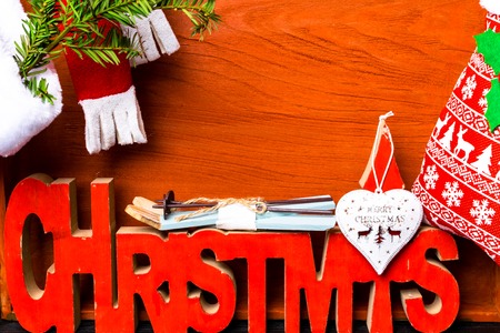 Christmas background with festive decoration, scarf, heart, skiing, deer, branch and Christmas sockの写真素材