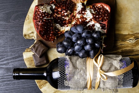 food and drink rich with iron, resveratrol, red wine in bottle with linen fabric , dark chocolate,...