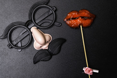 Colorful photo men glasses and moustaches, women lips on black background, closeupの写真素材