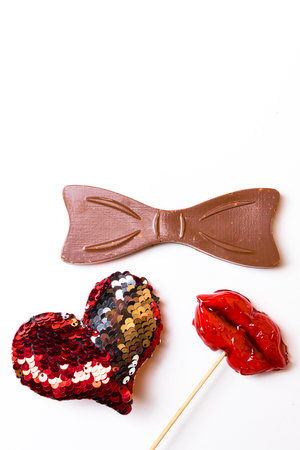 Top or flat lay view of Photo booth props a red lips and a black bow isolated on white, flat lay. Birthday parties and weddings, 14th februaryの写真素材
