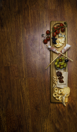 Traditional italian antipasto with prosciutto, parmesan cheese, sun-dried and cherry fresh tomatoes,...