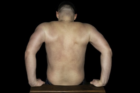 Activity, healthy lifestyle, fitness and sport. Man doing reverse push ups using chair. Back and...