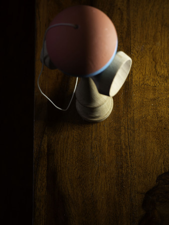 blurry shape of kendama Japan toy on wooden boardの写真素材