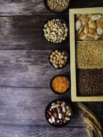 bean seeds, lentil, peas on wooden table, healthy rich with fiber food, food rich in vitamin A, E,...
