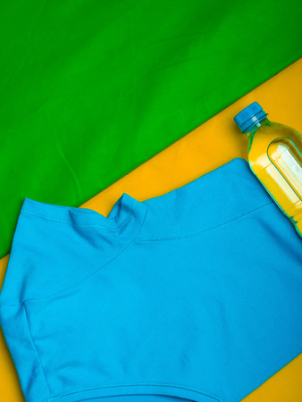 sport t-shirt and bottle of water on green mat, motivation conceptの写真素材