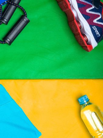 Sport background water tshirt expanders, sport shoe with copy space on green. gym training, healthy lifestyle, slim concept.の写真素材