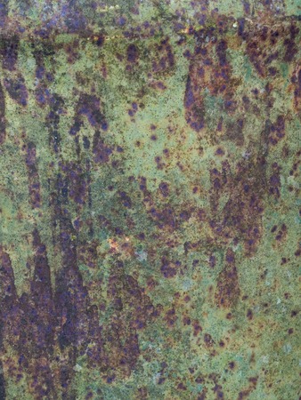 Old sheet of iron covered with a red-brown color with old green stained paint decaying metal. Turquoise grunge backgroundの写真素材