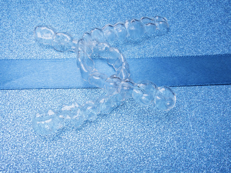 teeth braces. Invisible brackets on blue background