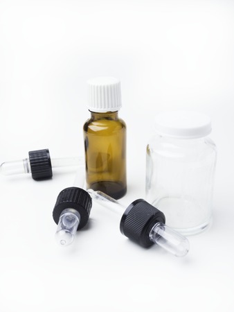 Brown and white medicine glass bottles with dropper isolated over white background, pipettes, Medical bankの写真素材