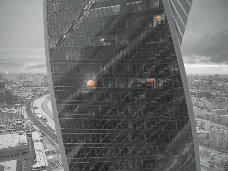 view of modern skyscrapers in business district, light in window of the multi-storey building of...