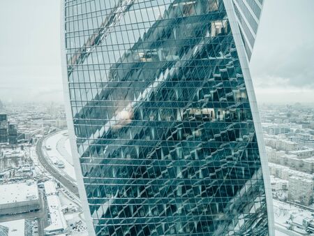 view of modern skyscrapers in business district, light in window of the multi-storey building of...