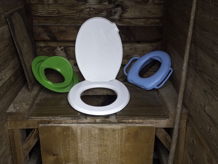 indoor yellow garden toilet in rustic style is made of wooden boards.