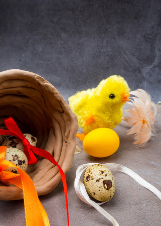 easter eggs decorated with colorful ribbon bows, yellow chicken toy the symbol of Easter, copy...